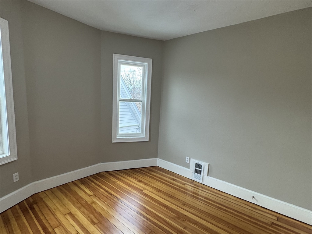 630 Metropolitan Avenue, Unit 3 Boston, MA 02136 - Photo 23 of 31 a view of empty room with wooden floor and fan
