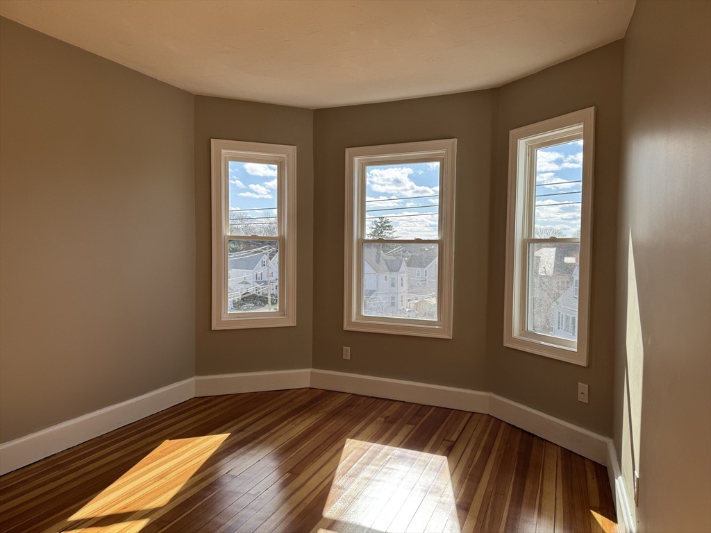 630 Metropolitan Avenue, Unit 3 Boston, MA 02136 - Photo 26 of 31 a view of a room with wooden floor and window