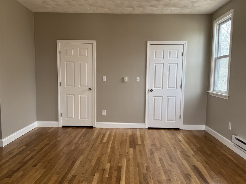 630 Metropolitan Avenue, Unit 3 Boston, MA 02136 - Photo 6 of 31 a view of front door with wooden floor