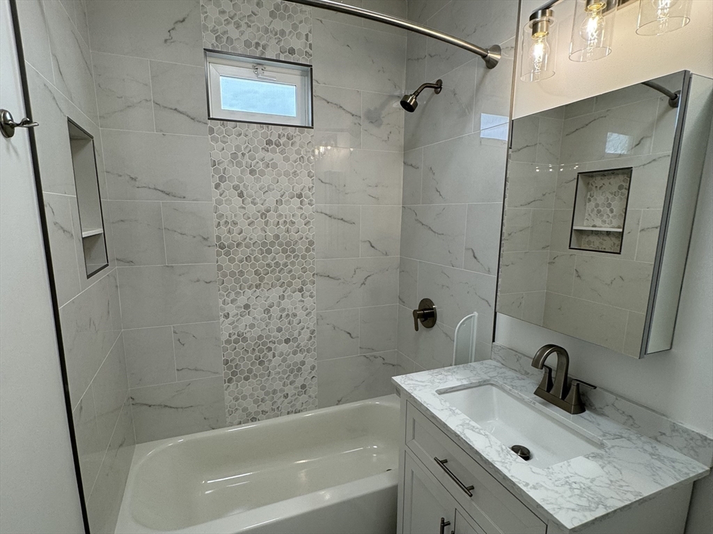 630 Metropolitan Avenue, Unit 3 Boston, MA 02136 - Photo 10 of 31 a bathroom with a sink and a shower