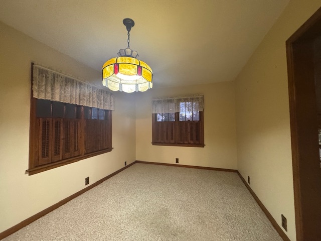 307 North Linden Street Clinton, IL 61727 - Photo 16 of 50 a view of an empty room with a window and chandelier fan