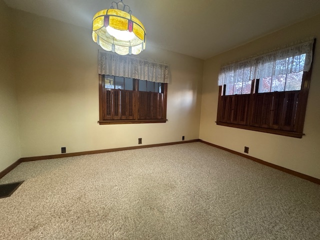 307 North Linden Street Clinton, IL 61727 - Photo 17 of 50 a view of an empty room with a window and dresser