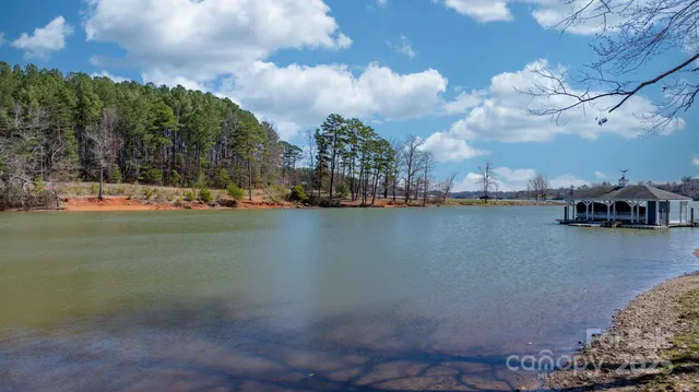 a view of a lake with lawn chairs