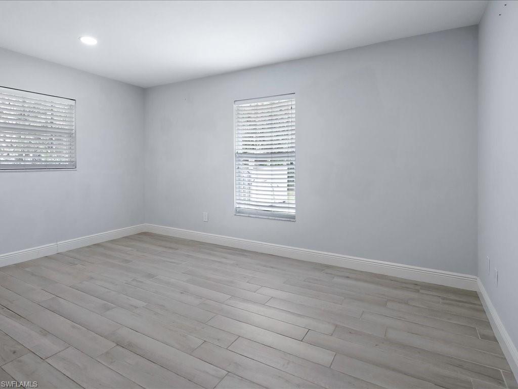 4220 11th Avenue Southwest Naples, FL 34116 - Photo 12 of 25 wooden floor in an empty room with a window