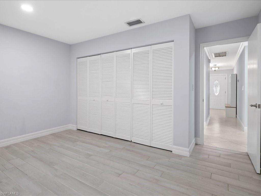 4220 11th Avenue Southwest Naples, FL 34116 - Photo 15 of 25 wooden floor in an empty room