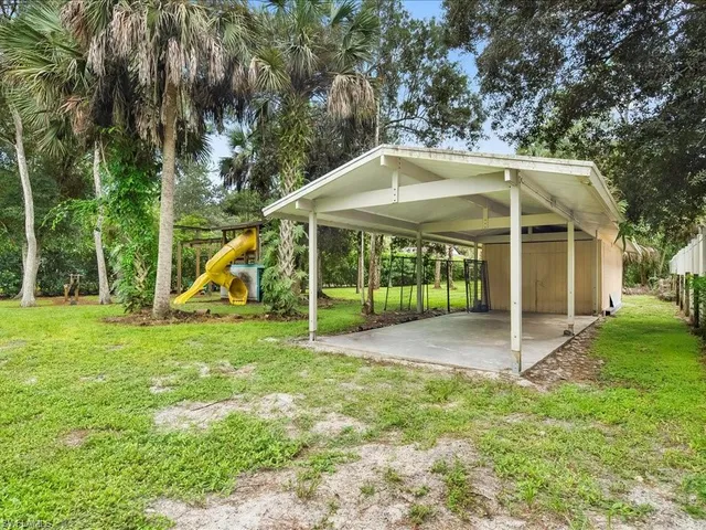 a view of a house with a yard and sitting area