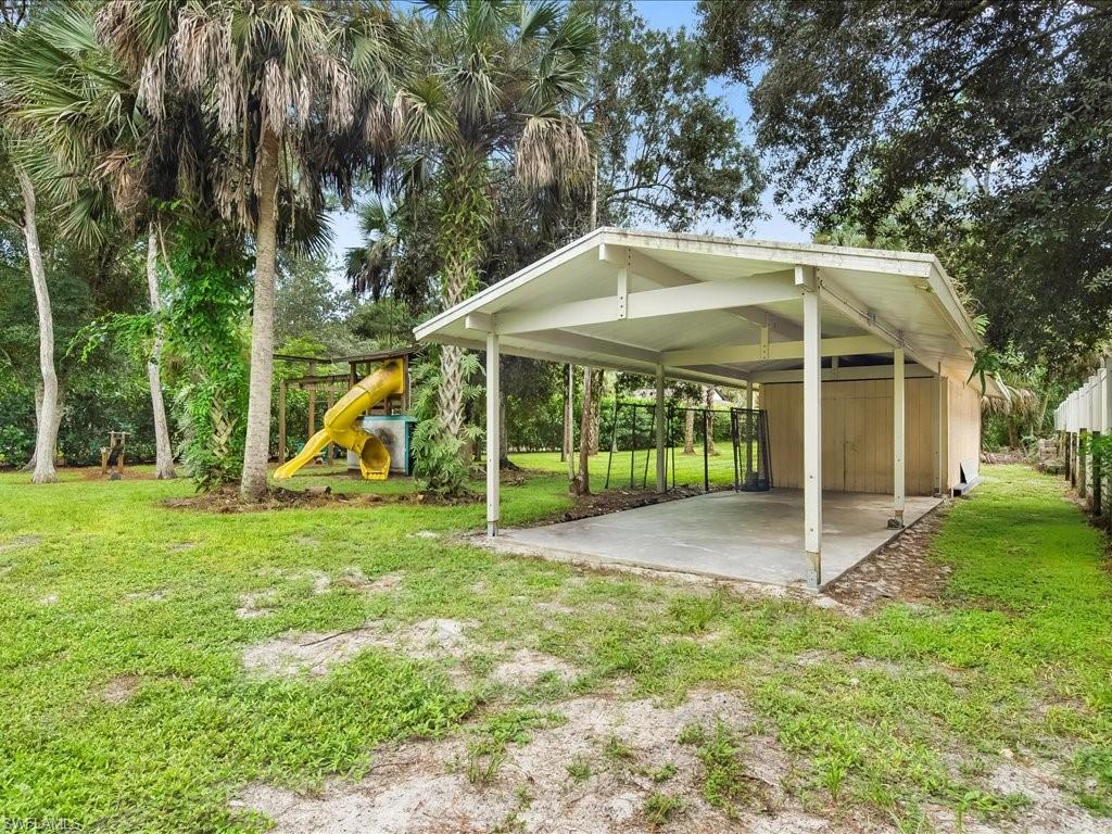 4220 11th Avenue Southwest Naples, FL 34116 - Photo 20 of 25 a view of a house with a yard and sitting area