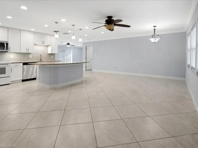 a view of kitchen with a sink appliances and cabinets