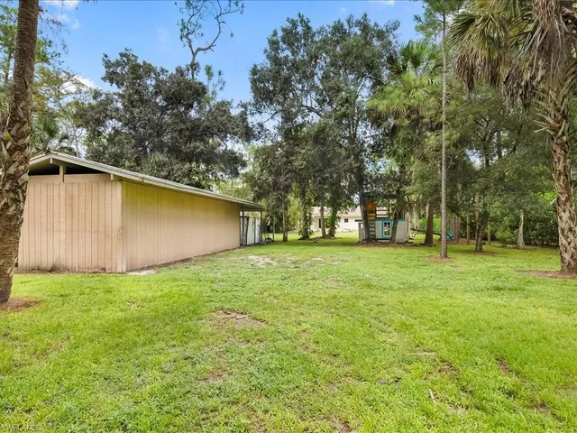 a view of a backyard with large trees