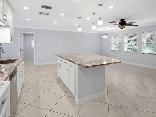 a kitchen with a sink a stove a microwave and a counter space