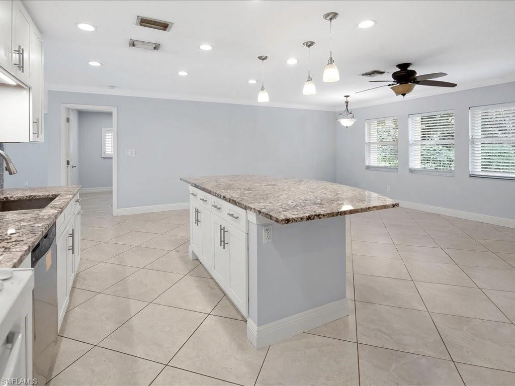 4220 11th Avenue Southwest Naples, FL 34116 - Photo 5 of 25 a kitchen with a sink a stove a microwave and a counter space