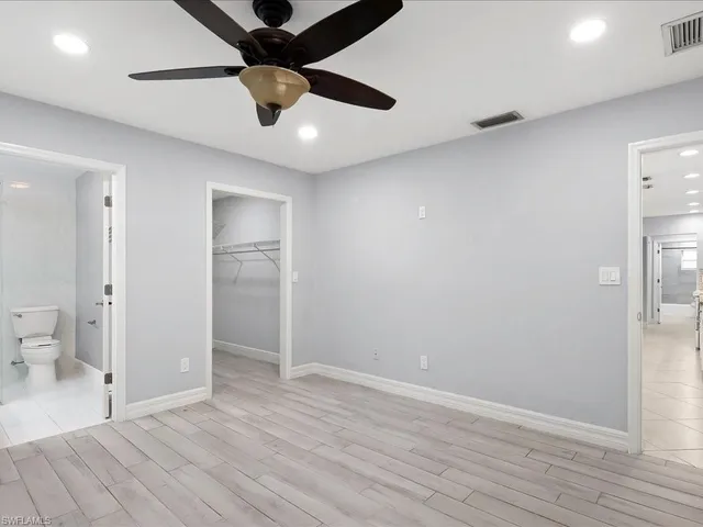 an empty room and a bathroom with a gallery