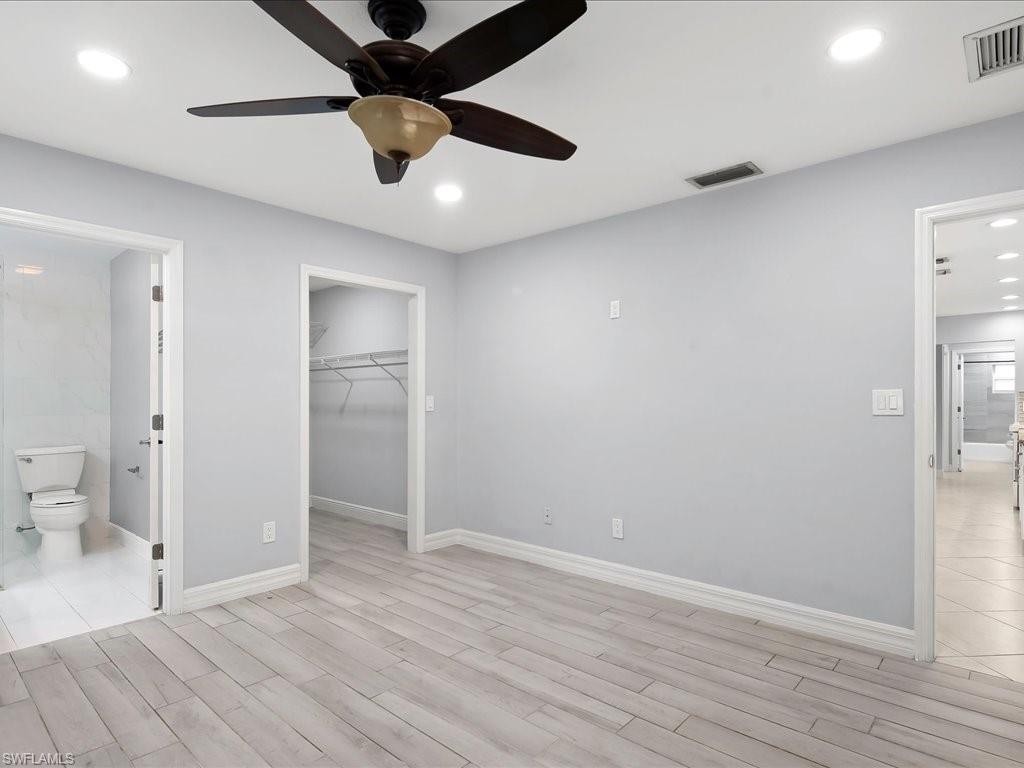 4220 11th Avenue Southwest Naples, FL 34116 - Photo 10 of 25 an empty room and a bathroom with a gallery