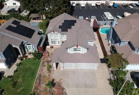 an aerial view of a house with garden space and street view