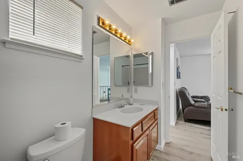 a bathroom with a sink a toilet and a mirror