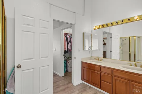 a spacious bathroom with a double vanity sink and a mirror