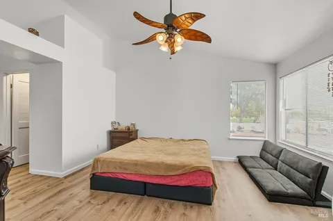 a bedroom with a bed couch and window