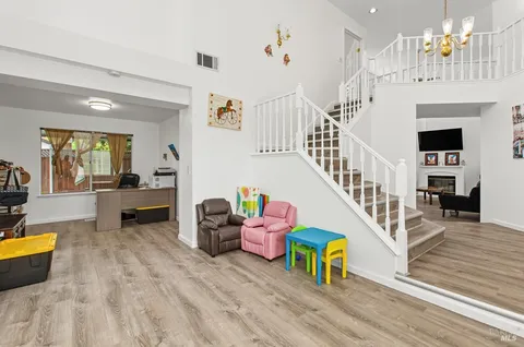 a living room with furniture and a chandelier