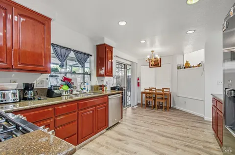a kitchen with stainless steel appliances granite countertop a sink and cabinets