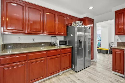 a kitchen with stainless steel appliances granite countertop a refrigerator and a sink