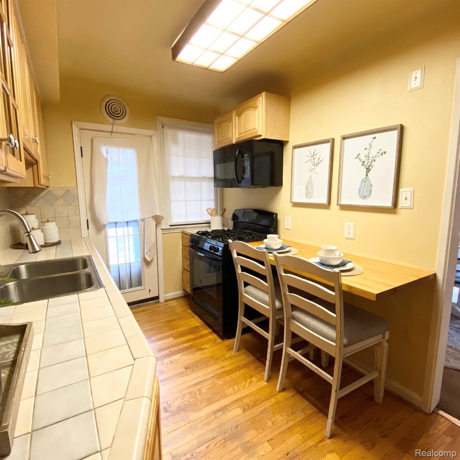 20424 Stratford Road Detroit, MI 48221 - Photo 10 of 19 Hardwood floors, custom tile countertops, butcher block countertop and all appliances.