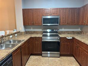 6351 Landings Way Tamarac, FL 33321 - Photo 11 of 16 a kitchen with a sink stove and microwave