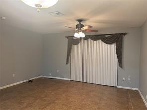 6351 Landings Way Tamarac, FL 33321 - Photo 12 of 16 an empty room with a chandelier fan and windows