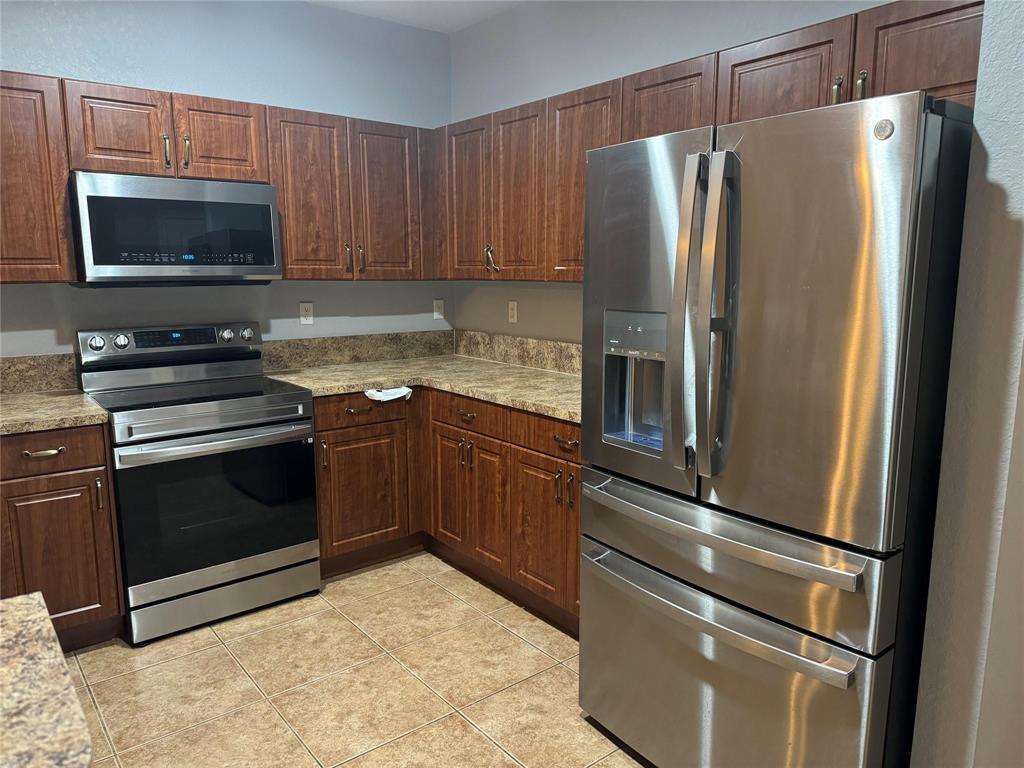 6351 Landings Way Tamarac, FL 33321 - Photo 2 of 16 a kitchen with a refrigerator stove and microwave