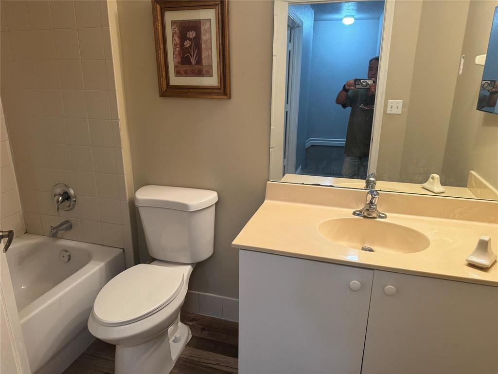 6351 Landings Way Tamarac, FL 33321 - Photo 6 of 16 a bathroom with a toilet sink and mirror