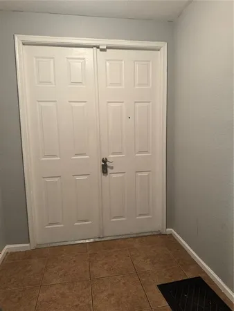 a view of a hallway with wooden floor and closet