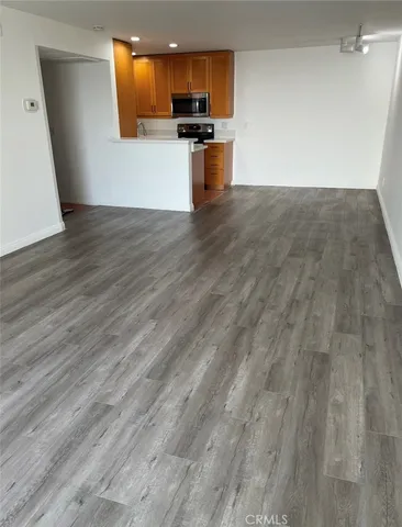 a kitchen with granite countertop a stove and cabinets