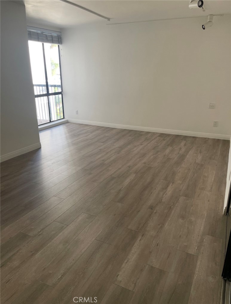 8530 Holloway Drive, Unit 418 Los Angeles, CA 90069 - Photo 6 of 13 wooden floor in an empty room with a window