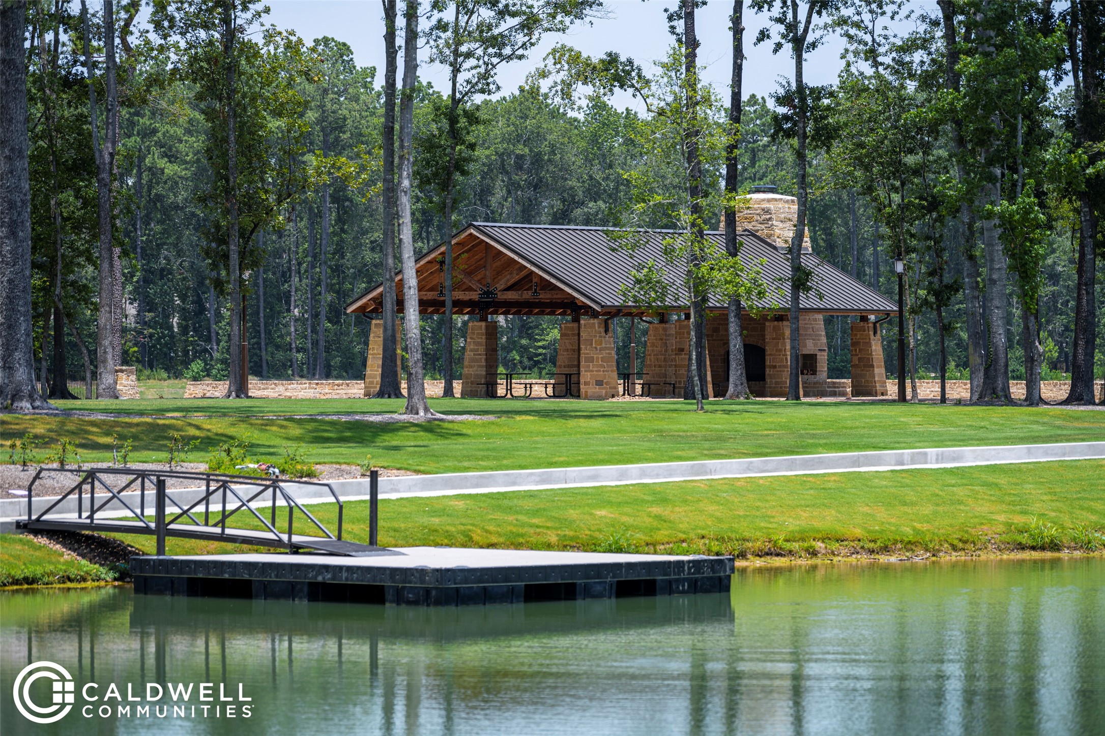 22920 Mist Fls Court Porter, TX 77365 - Photo 35 of 35 a view of a house next to a lake with a big yard and large trees