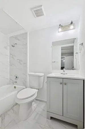 a bathroom with a toilet a sink and a bathtub