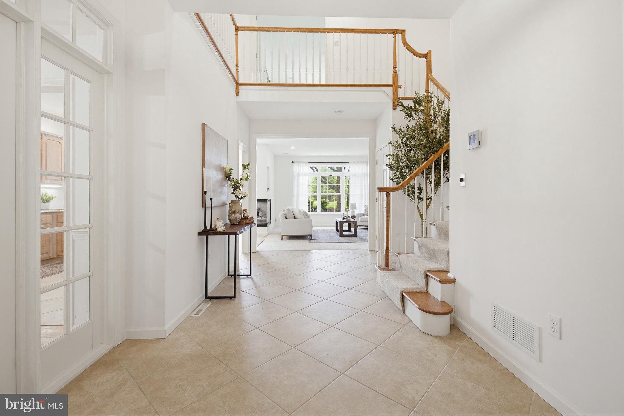 634 Northfield Road Lititz, PA 17543 - Photo 11 of 45 a view of a hallway with dining area and chandelier