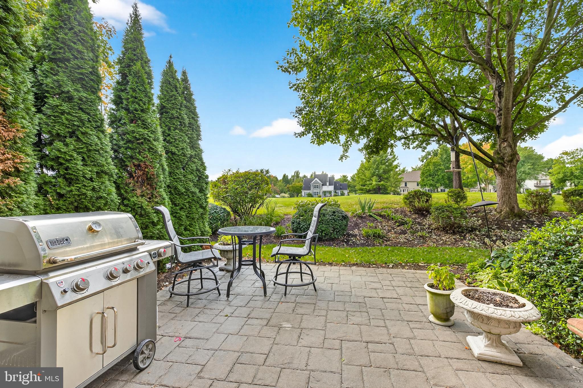 634 Northfield Road Lititz, PA 17543 - Photo 39 of 45 a view of a patio with table and chairs potted plants and a large tree