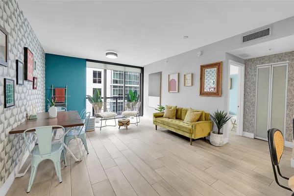 a dining room with furniture and wooden floor