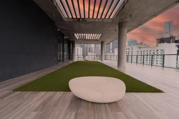 a view of a terrace with furniture and a garden