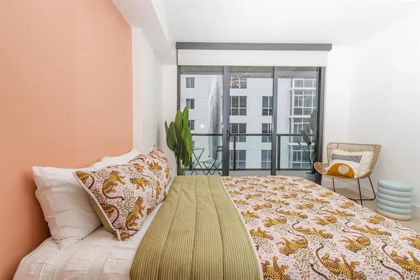 a bedroom with a bed and a chandelier