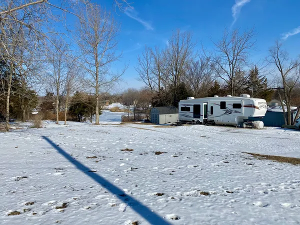 a view of a yard with snow on the road