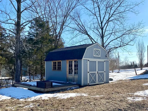 a view of a house with a yard covered in snow