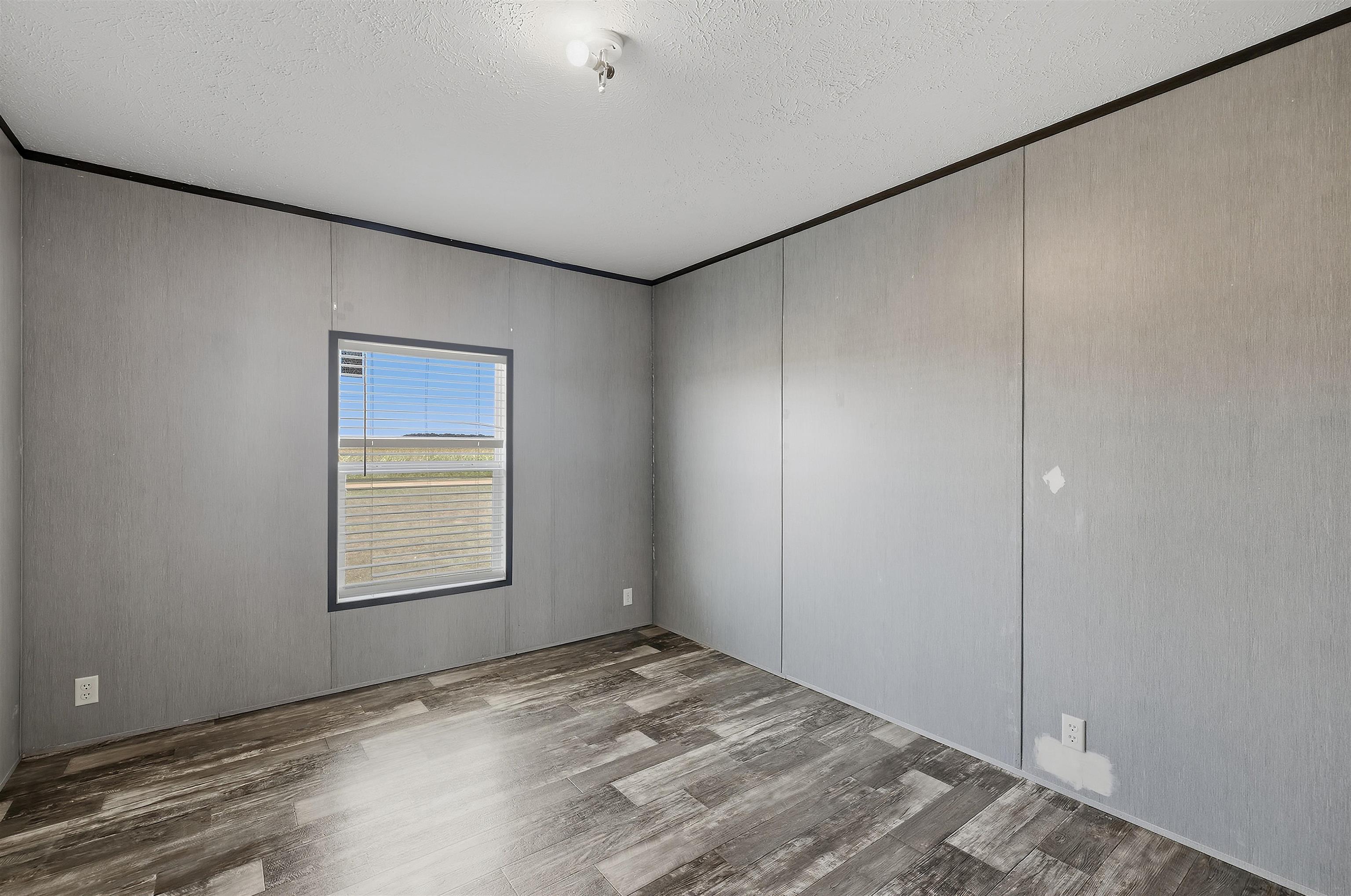 664 Rialto Road Covington, TN 38019 - Photo 18 of 24 Spacious room featuring wood-finish flooring and a single window with blinds