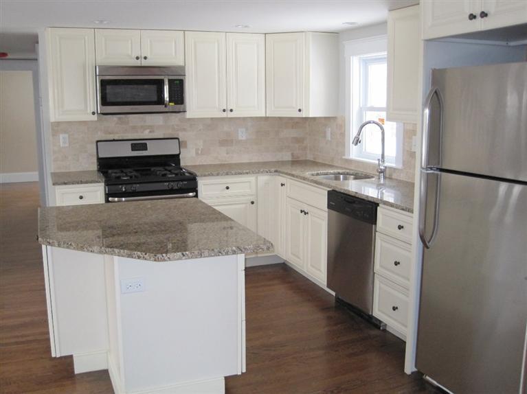 126 Old Town Road Hyannis, MA 02601 - Photo 3 of 13 a kitchen with white cabinets and stainless steel appliances