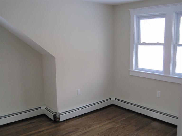 126 Old Town Road Hyannis, MA 02601 - Photo 7 of 13 an empty room with wooden floor and windows