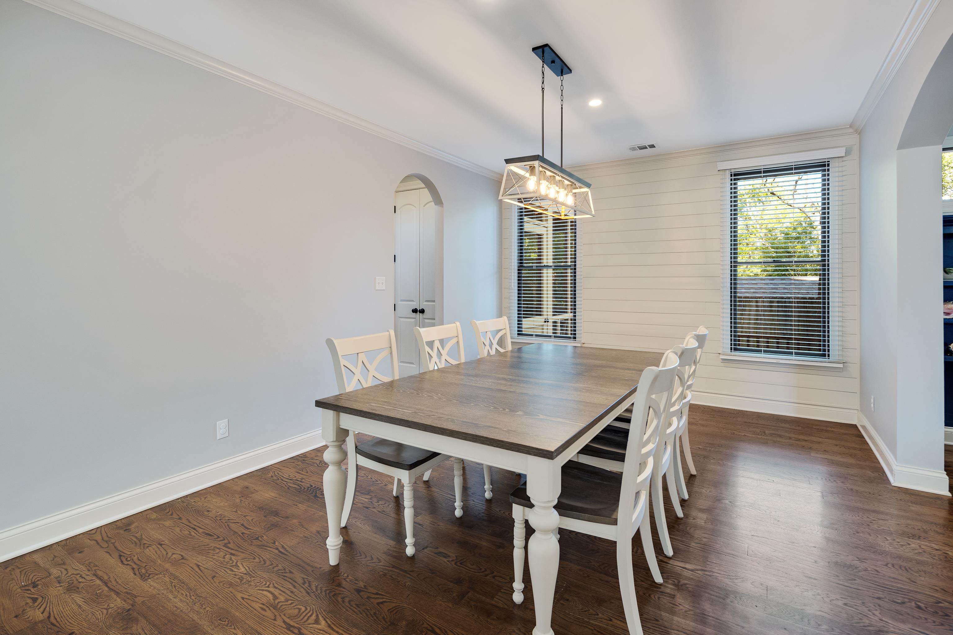 237 Windover Road Memphis, TN 38111 - Photo 13 of 37 Dining space featuring arched walkways, crown molding, dark wood finished floors, wooden walls, and recessed lighting