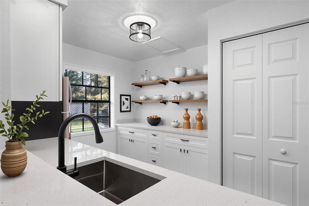 2722 Graduate Court Orlando, FL 32826 - Photo 12 of 33 a kitchen with a white stove and cabinets