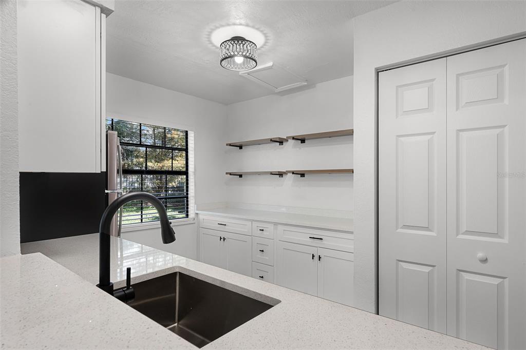 2722 Graduate Court Orlando, FL 32826 - Photo 13 of 33 a kitchen with cabinets and window