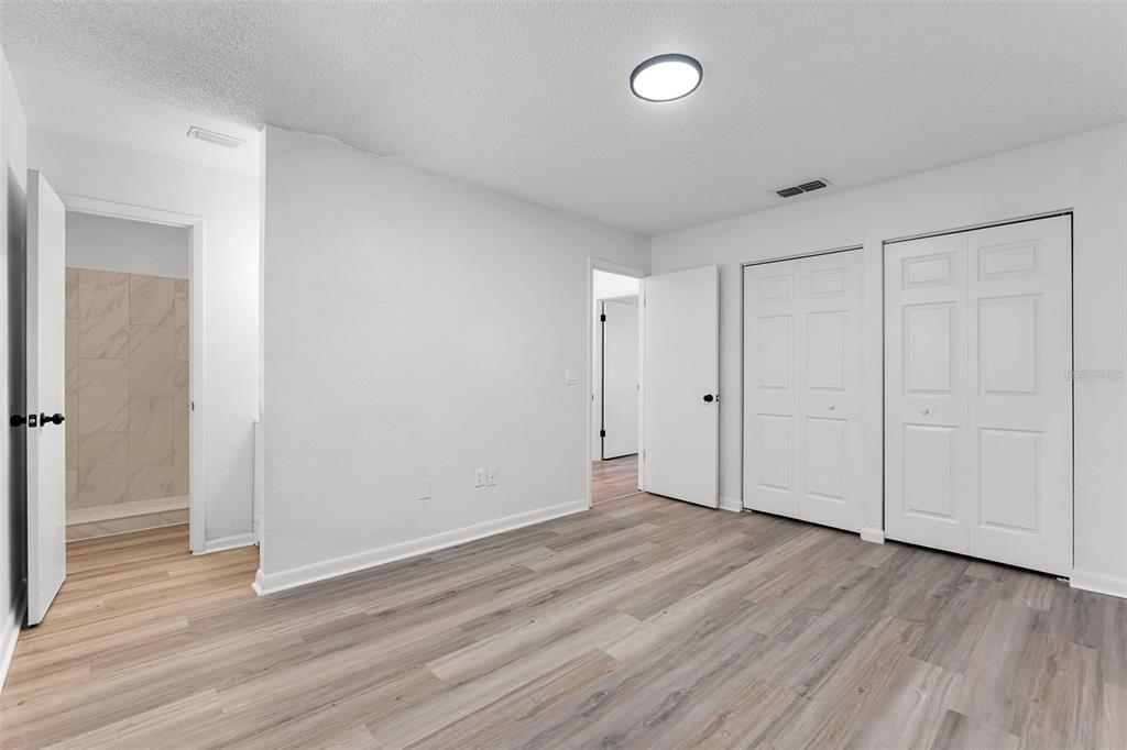 2722 Graduate Court Orlando, FL 32826 - Photo 18 of 33 a view of an empty room and wooden floor