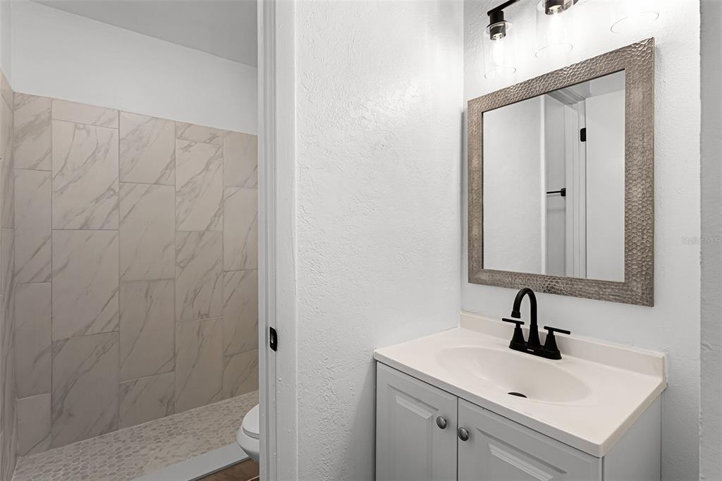 2722 Graduate Court Orlando, FL 32826 - Photo 19 of 33 a bathroom with a sink and mirror