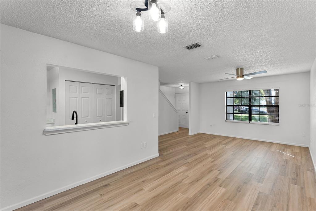 2722 Graduate Court Orlando, FL 32826 - Photo 9 of 33 wooden floor in an empty room with a window